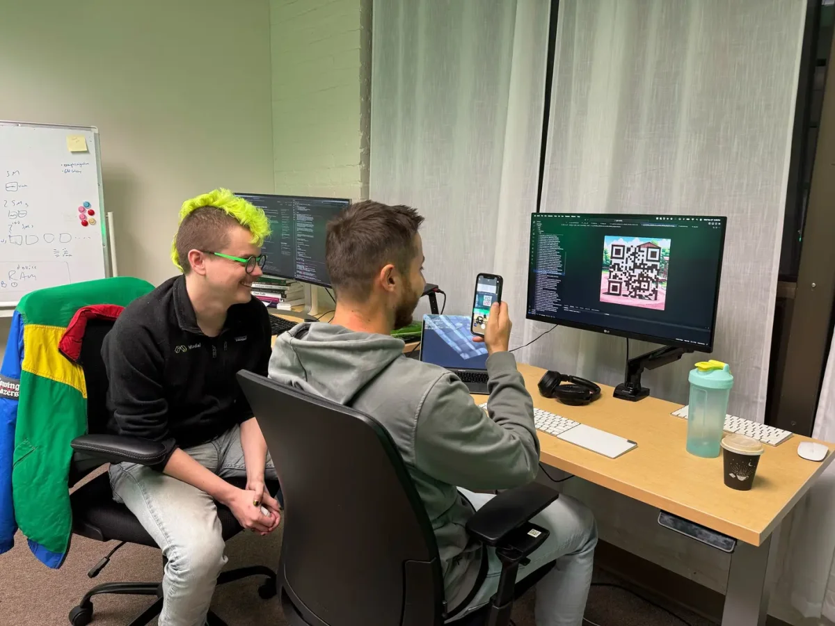 Two authors manually checking QArt codes